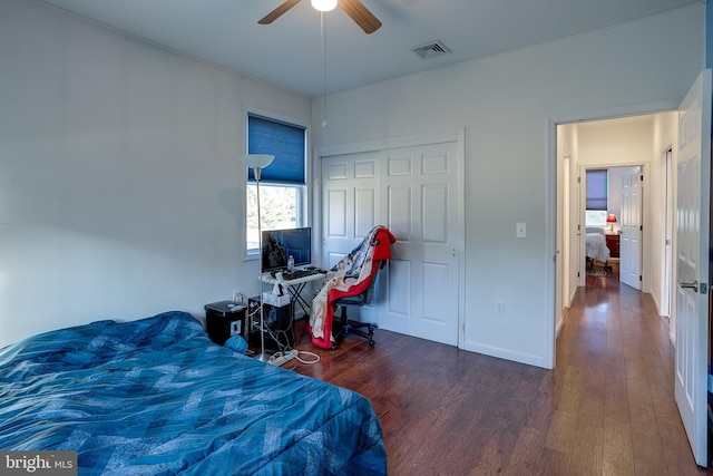 bedroom with a closet, ceiling fan, and dark hardwood / wood-style floors