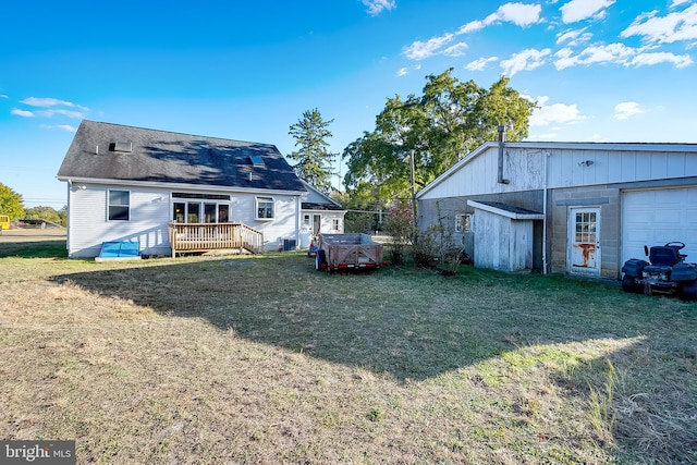 rear view of property featuring a deck and a lawn