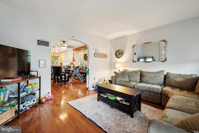 living room featuring wood-type flooring and ceiling fan