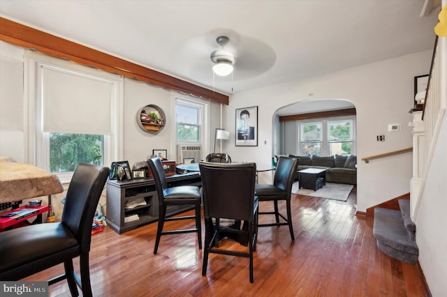 dining area with wood-type flooring, ceiling fan, and a healthy amount of sunlight