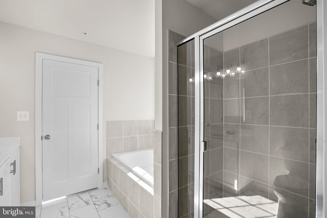 bathroom featuring vanity and shower with separate bathtub