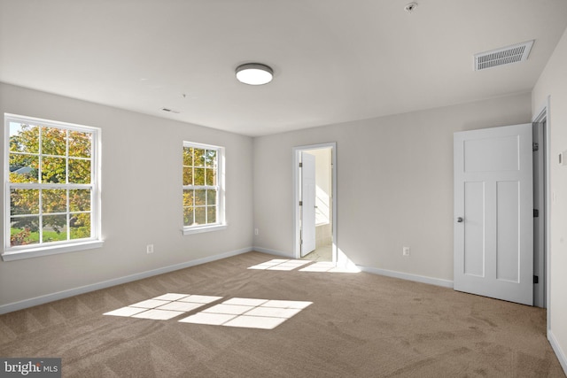 unfurnished room with light carpet