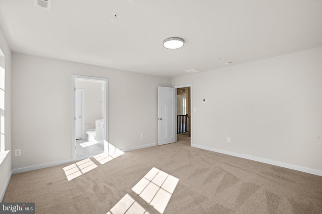 unfurnished room with light colored carpet