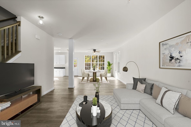 living room featuring hardwood / wood-style floors and ceiling fan