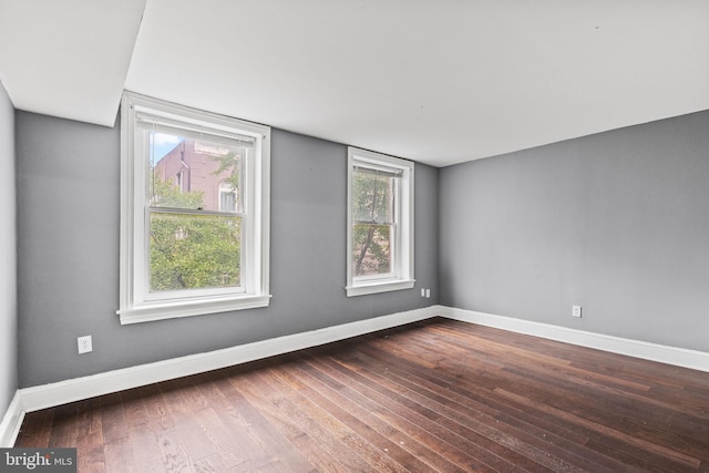 empty room with hardwood / wood-style floors