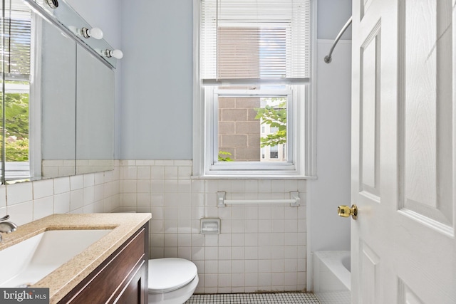 full bathroom featuring a wealth of natural light, tile patterned flooring, vanity, and toilet