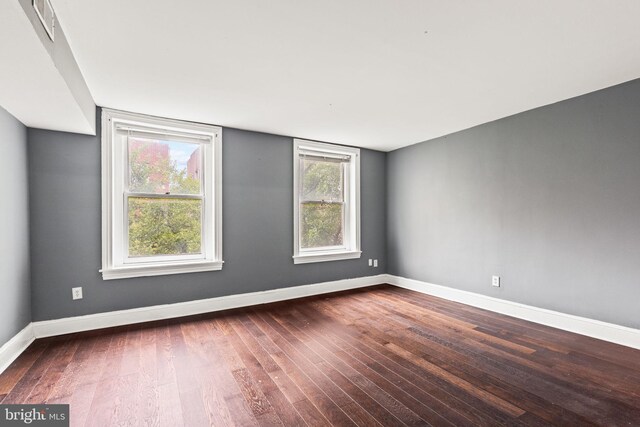 unfurnished room featuring dark hardwood / wood-style floors