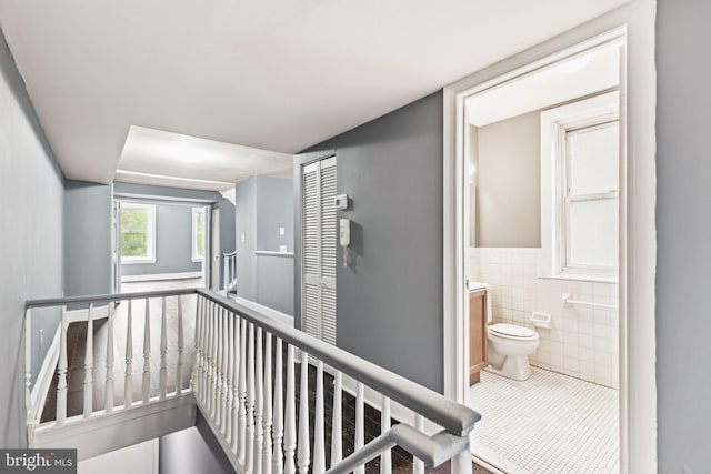 hall featuring tile walls and tile patterned flooring