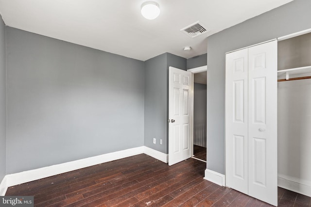 unfurnished bedroom featuring dark hardwood / wood-style floors