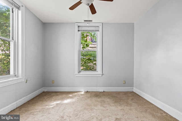 carpeted empty room featuring ceiling fan