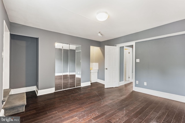 unfurnished bedroom featuring dark hardwood / wood-style floors