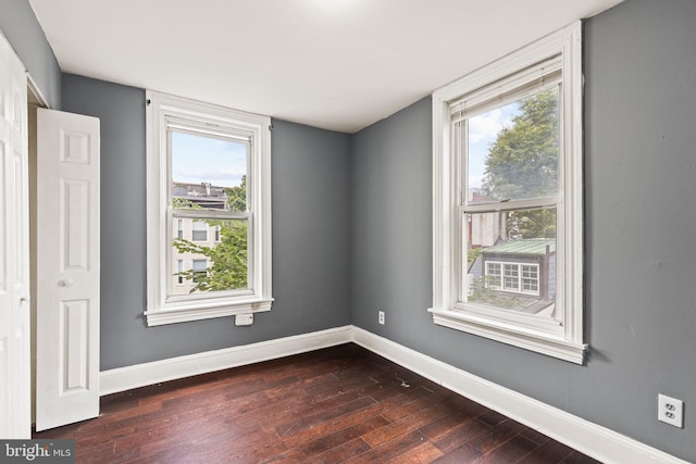 spare room with dark wood-type flooring