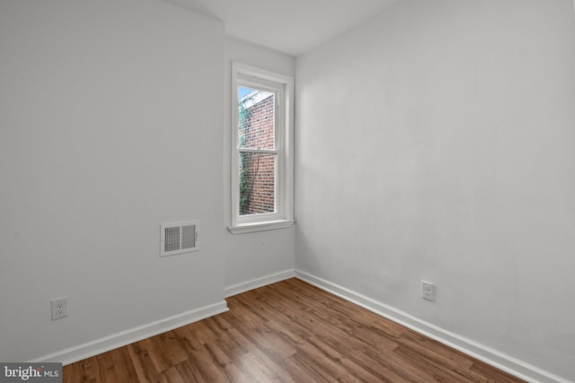 spare room with hardwood / wood-style floors