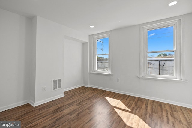 unfurnished room featuring dark wood-type flooring