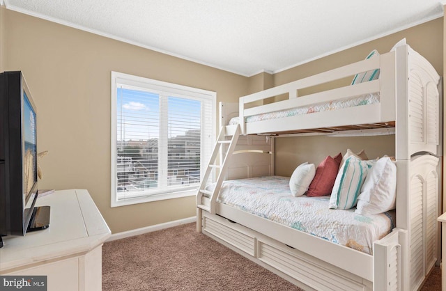 carpeted bedroom with crown molding and a textured ceiling