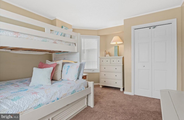 bedroom with light colored carpet, a closet, and crown molding