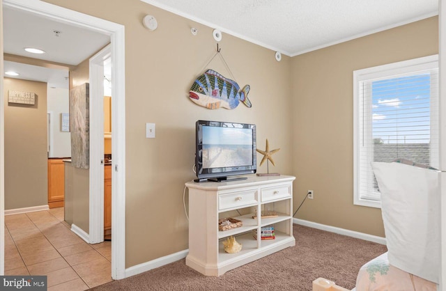 interior space featuring crown molding, light tile patterned floors, and a textured ceiling