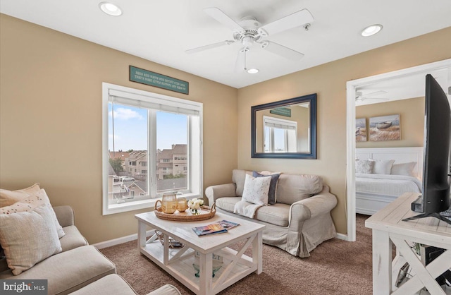 carpeted living room featuring ceiling fan