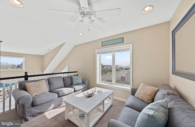 carpeted living room with ceiling fan