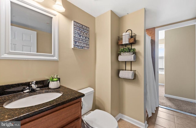 bathroom with tile patterned floors, vanity, and toilet