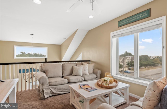 carpeted living room with a wealth of natural light and ceiling fan