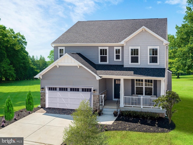 craftsman inspired home with a front yard, concrete driveway, covered porch, and roof with shingles