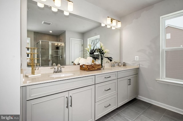 bathroom featuring tile patterned floors, an enclosed shower, and vanity