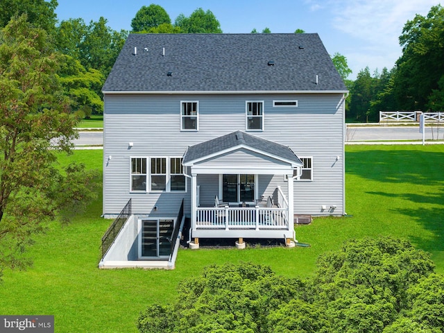 rear view of property featuring a wooden deck and a yard