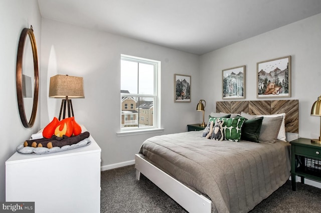 carpeted bedroom featuring baseboards