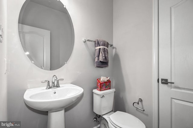 bathroom with toilet and a sink