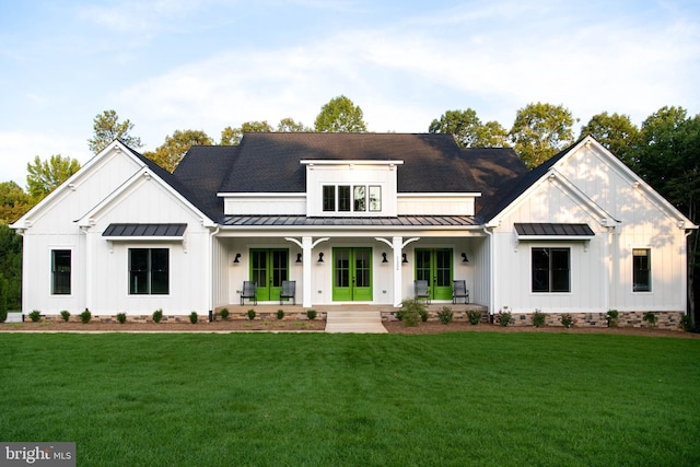 modern farmhouse with a front lawn and a porch