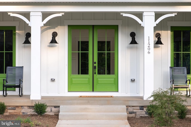 view of exterior entry featuring covered porch