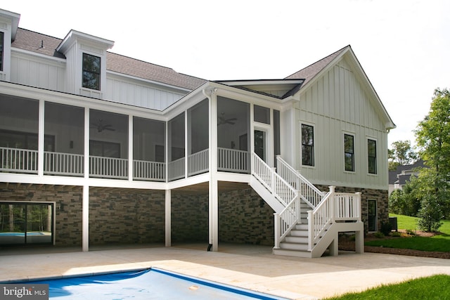 back of house with a sunroom and a patio area