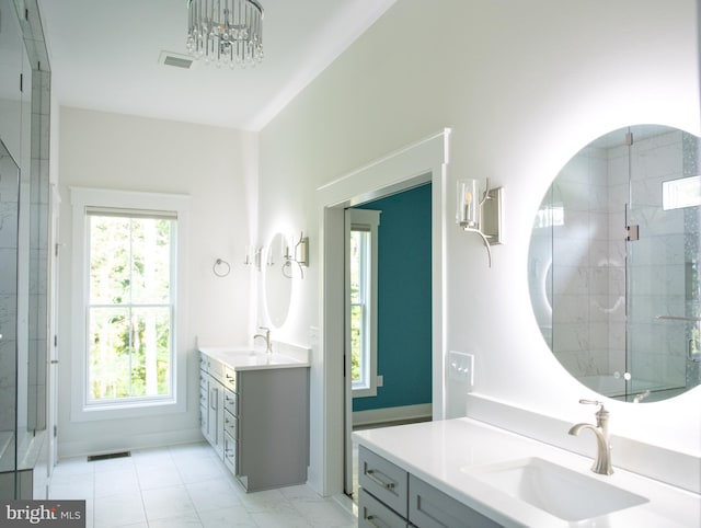 bathroom with tiled shower and vanity