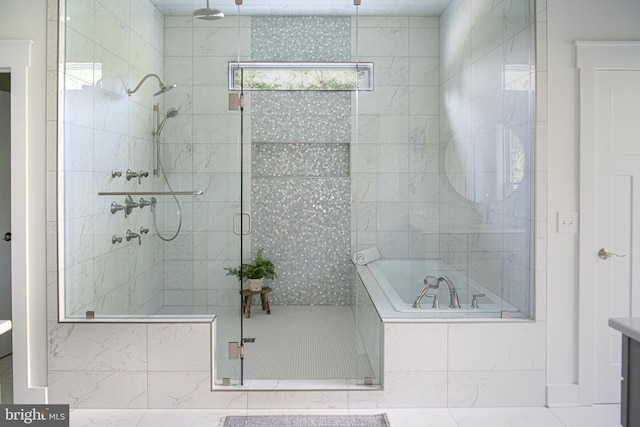 bathroom featuring independent shower and bath