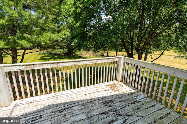 wooden terrace with a lawn