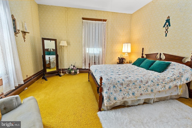bedroom with carpet flooring and wallpapered walls