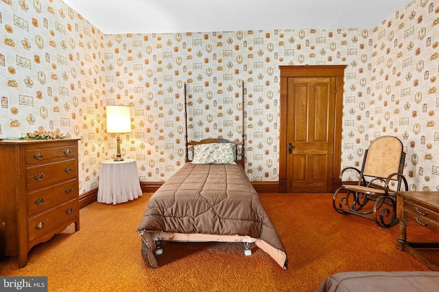 carpeted bedroom with baseboards and wallpapered walls