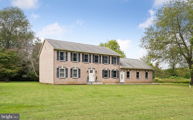 colonial home with a front lawn