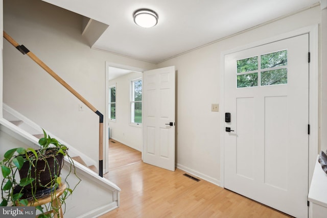 entrance foyer featuring light wood-type flooring and a healthy amount of sunlight