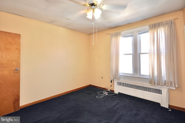 carpeted spare room with baseboards, ceiling fan, and radiator heating unit