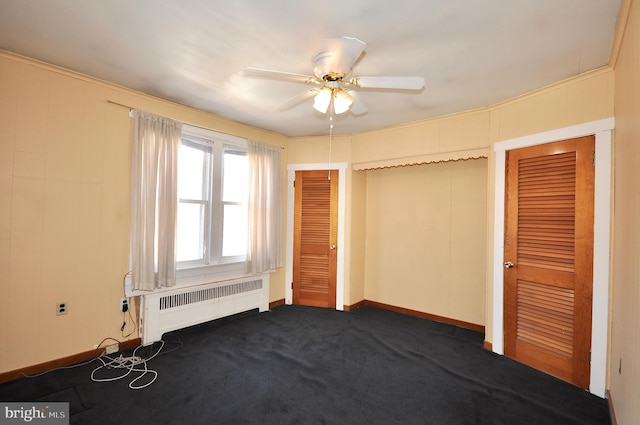 unfurnished bedroom with baseboards, radiator heating unit, a ceiling fan, and carpet flooring