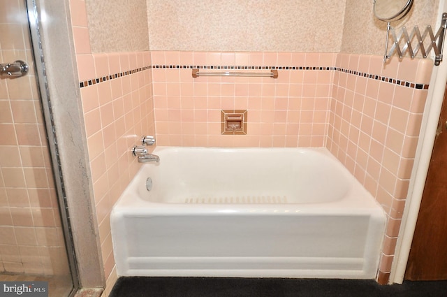 bathroom with wallpapered walls