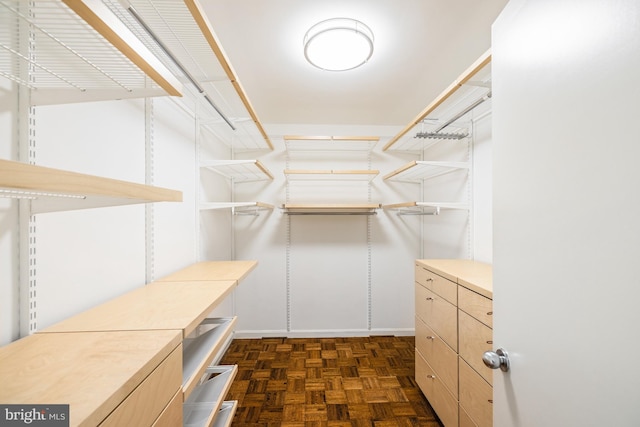 walk in closet featuring dark parquet floors