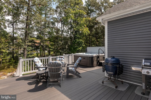 wooden deck with a hot tub and area for grilling