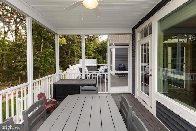 unfurnished sunroom featuring ceiling fan