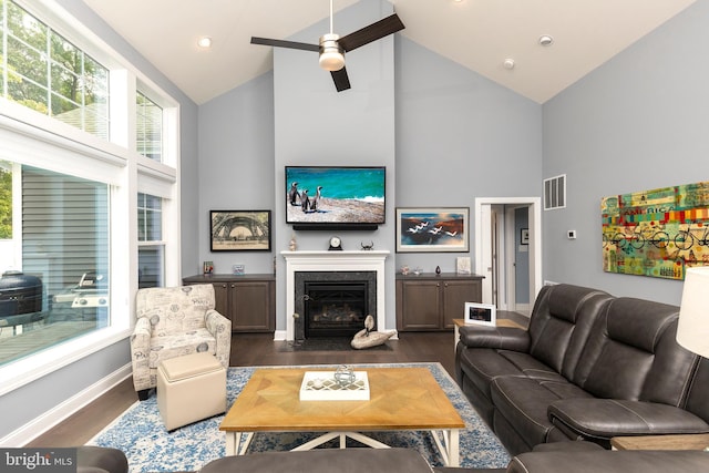 living room featuring ceiling fan, dark hardwood / wood-style floors, and high vaulted ceiling