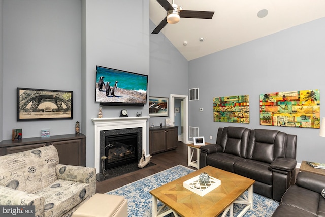 living room with ceiling fan, dark wood-type flooring, and high vaulted ceiling