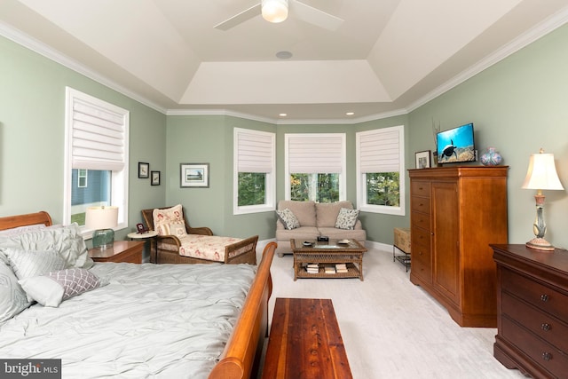 bedroom featuring ornamental molding, a tray ceiling, and ceiling fan