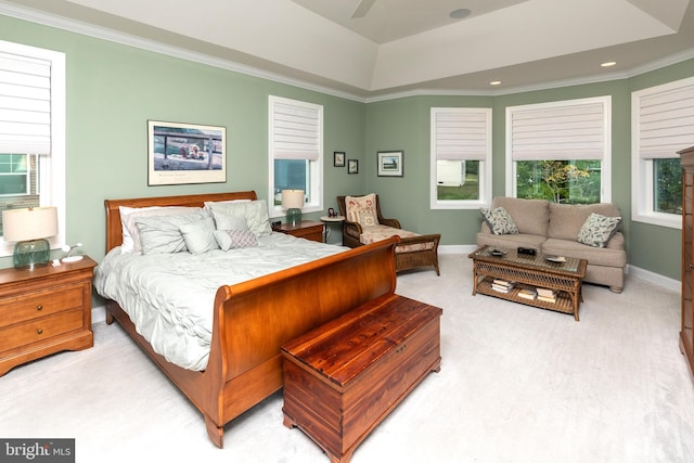 carpeted bedroom with ceiling fan, ornamental molding, and multiple windows